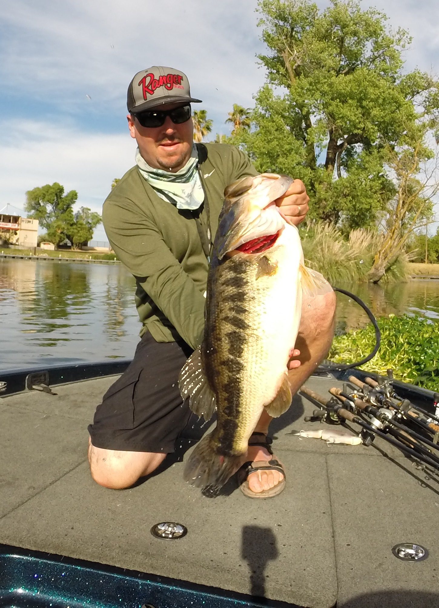 Man holding a large bass on boat