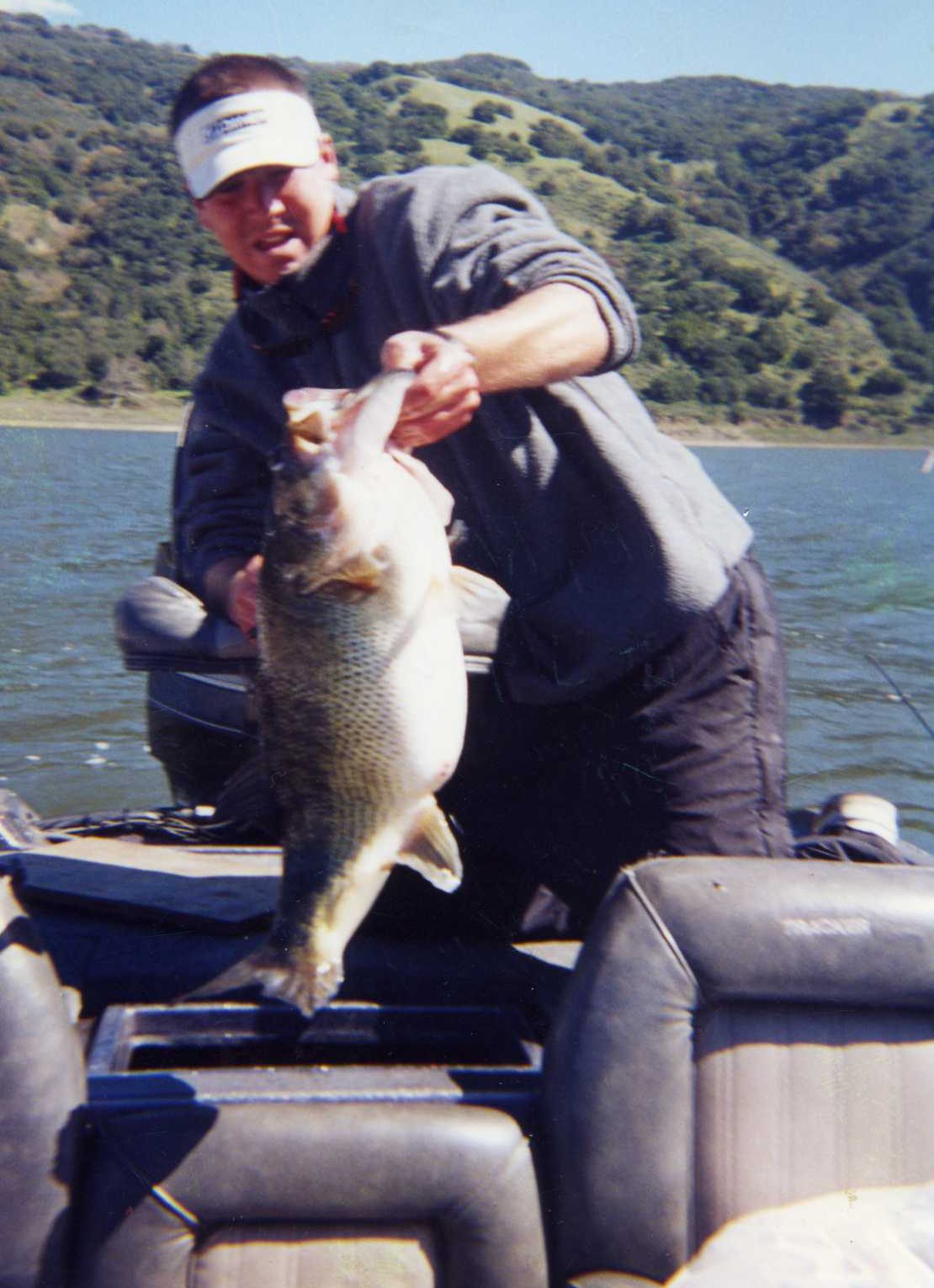 Person displaying big catch on lake